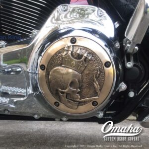 Custom derby cover made from cast bronze with decorative sculpt design installed on Harley Davidson motorcycle.
