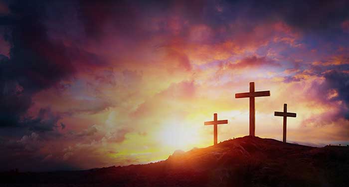 Christian crosses on a hill at sunset