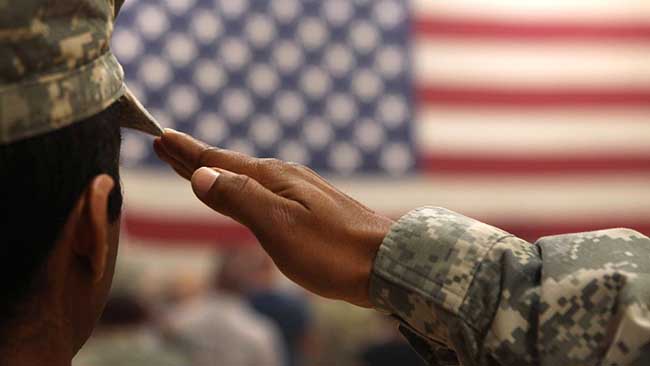 Service member saluting the United States Flag