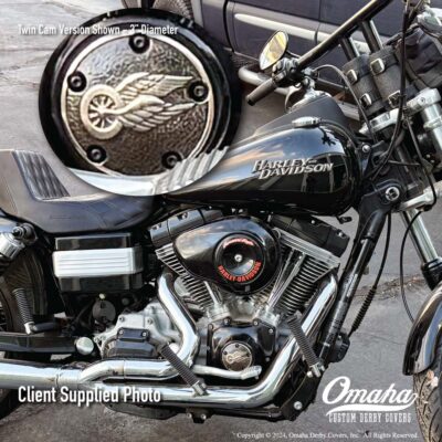 Custom made bronze timing cover mounted on a Harley-Davidson Dyna motorcycle