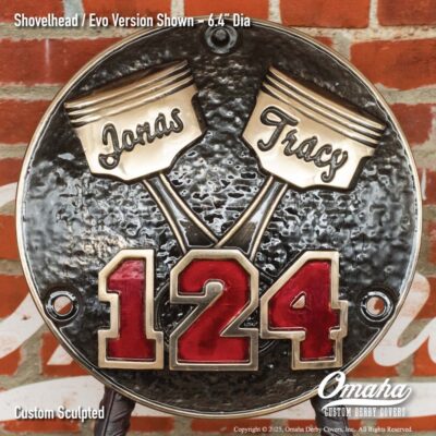 Custom derby cover for Harley-Davidson with crossed pistons design