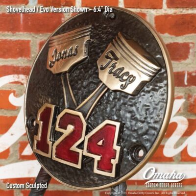 Custom derby cover for Harley-Davidson with crossed pistons design