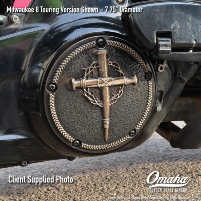 Custom derby cover with nail cross design installed on a Harley-Davidson motorcycle