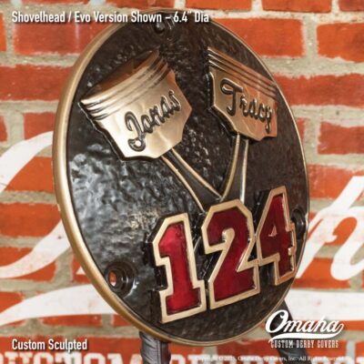 Custom derby cover for Harley-Davidson with crossed pistons design